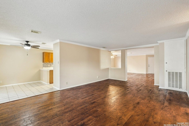 spare room with a textured ceiling, light hardwood / wood-style floors, ceiling fan, and ornamental molding