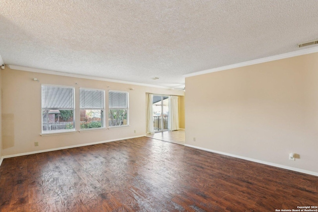 empty room with hardwood / wood-style floors, a textured ceiling, and ornamental molding