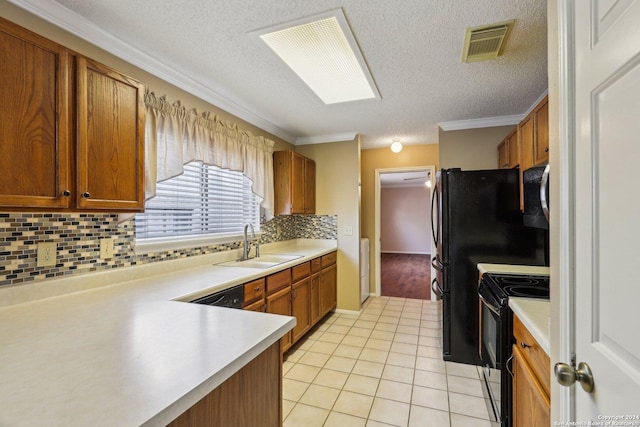 kitchen with tasteful backsplash, sink, light tile patterned flooring, and black appliances