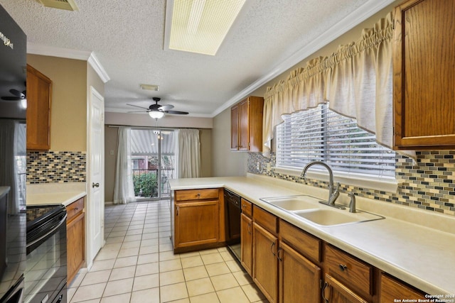 kitchen with kitchen peninsula, tasteful backsplash, a textured ceiling, black appliances, and sink