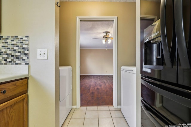 kitchen with backsplash, ceiling fan, light tile patterned floors, a textured ceiling, and washer / dryer