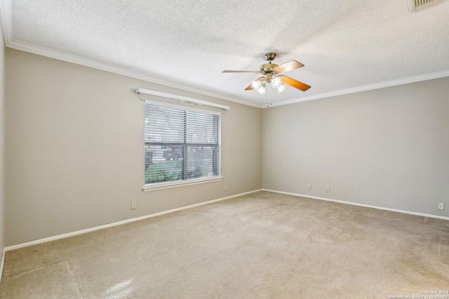 carpeted empty room featuring ceiling fan, a textured ceiling, and ornamental molding