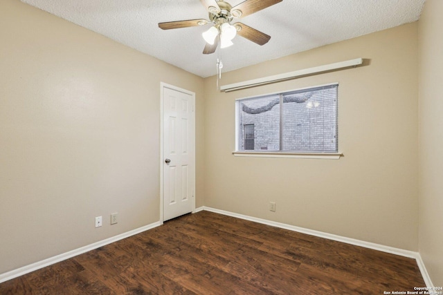 spare room featuring ceiling fan, dark hardwood / wood-style flooring, and a textured ceiling