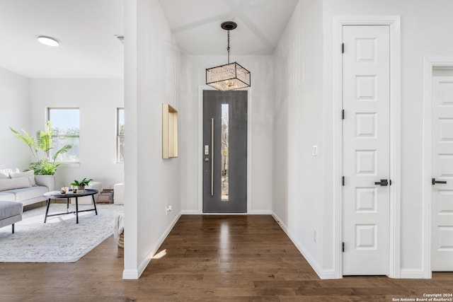 foyer with dark hardwood / wood-style floors and an inviting chandelier