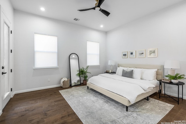 bedroom with dark hardwood / wood-style floors and ceiling fan