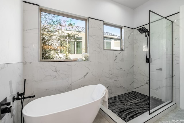 bathroom featuring independent shower and bath