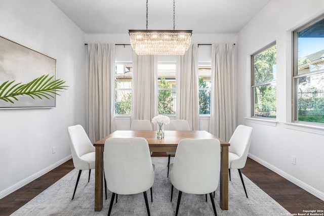 dining area with a chandelier, dark hardwood / wood-style flooring, and a wealth of natural light