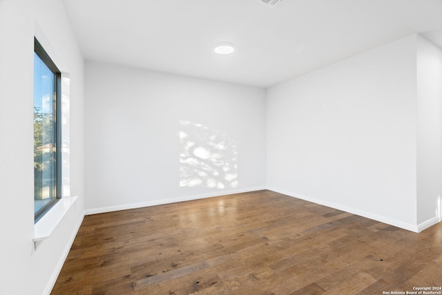 empty room with dark hardwood / wood-style floors