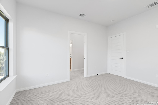 spare room with light colored carpet