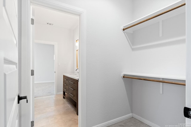 walk in closet featuring sink