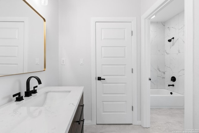 bathroom featuring vanity and tiled shower / bath