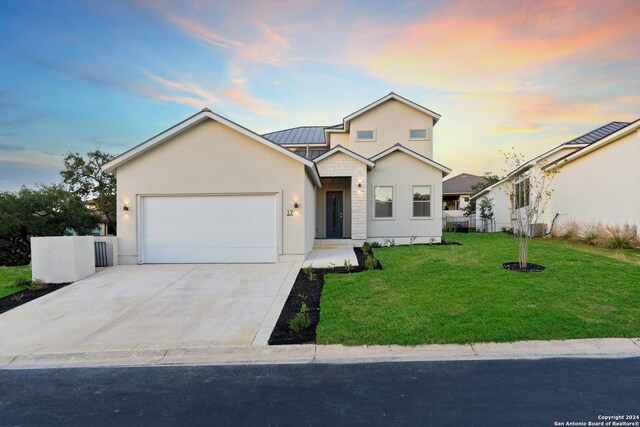 front facade with a lawn and a garage