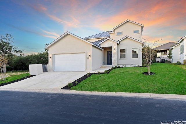 view of front of property with a lawn and a garage