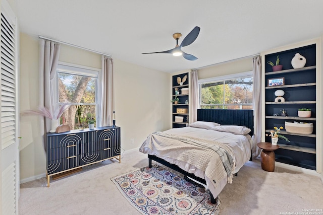 bedroom with ceiling fan and light colored carpet