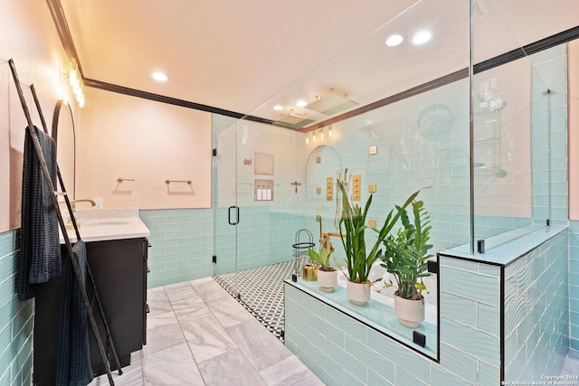 bathroom with crown molding, a shower with door, vanity, and tile walls