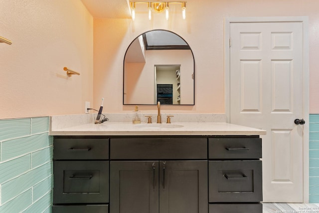 bathroom with vanity and crown molding