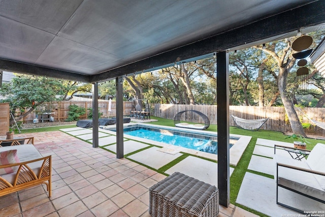 view of pool featuring a lawn and a patio area