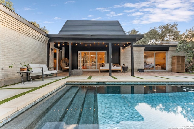 view of swimming pool with an outdoor hangout area and a patio