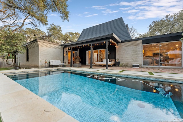 view of swimming pool featuring a patio area