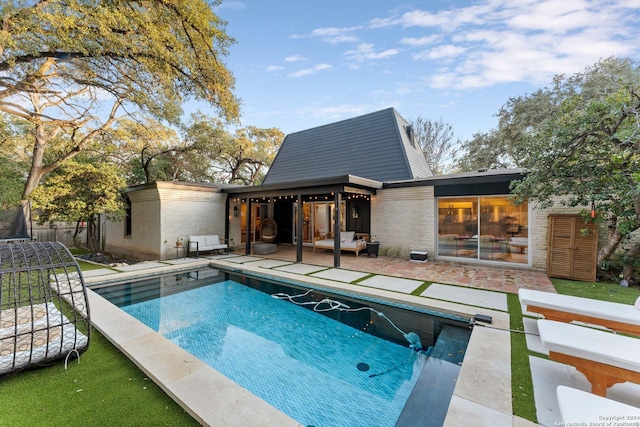 view of swimming pool featuring a patio area and a trampoline