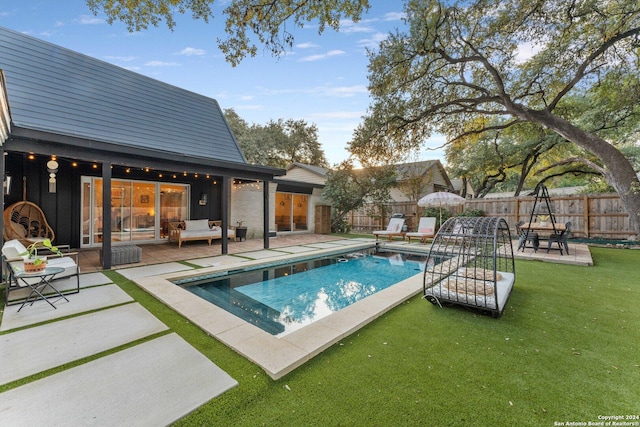 view of pool featuring a patio area and a lawn