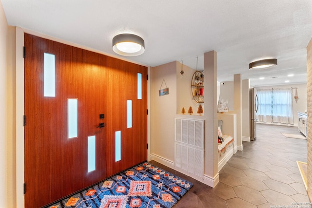 foyer entrance with wood walls