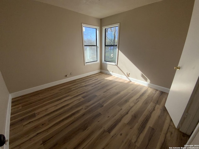 unfurnished room featuring dark hardwood / wood-style flooring