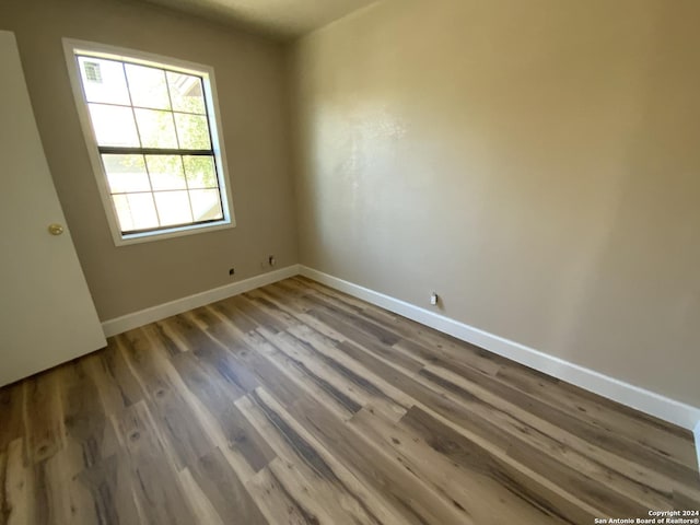 spare room with hardwood / wood-style floors