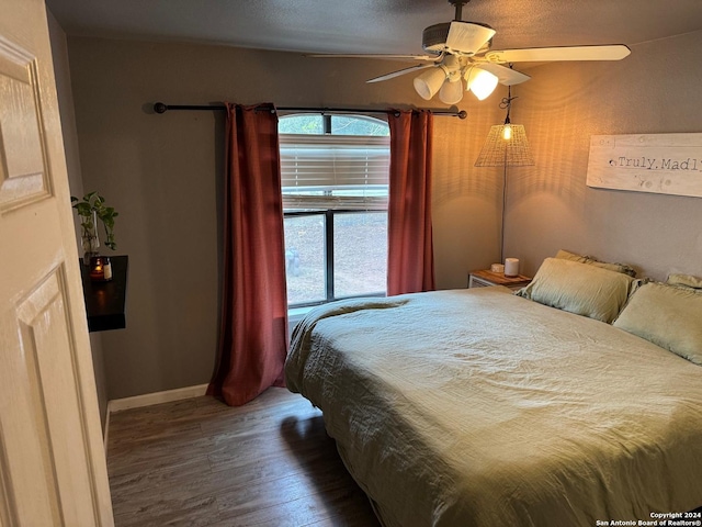 bedroom with hardwood / wood-style floors and ceiling fan