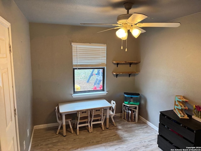 playroom with ceiling fan and light hardwood / wood-style floors