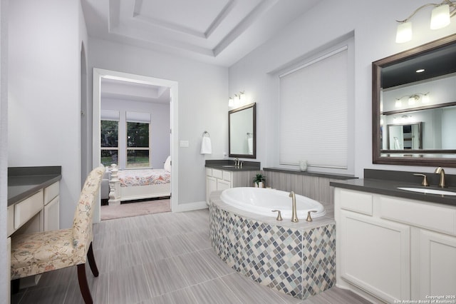 bathroom featuring tiled bath and vanity