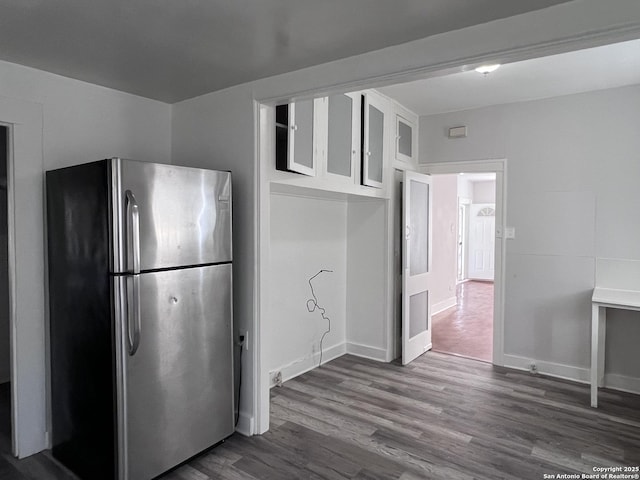 kitchen featuring white cabinetry, hardwood / wood-style floors, and stainless steel refrigerator