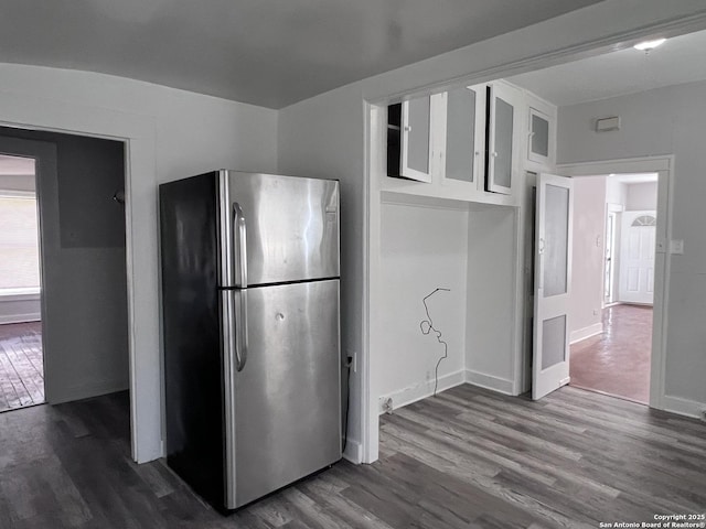 kitchen featuring dark hardwood / wood-style floors, white cabinetry, and stainless steel fridge