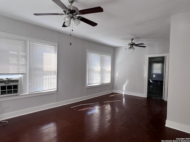 unfurnished room featuring dark wood-type flooring, cooling unit, and ceiling fan