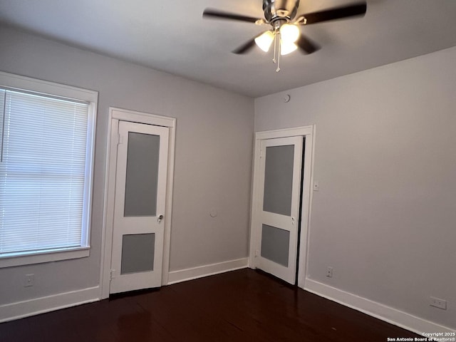 interior space with dark hardwood / wood-style floors and ceiling fan