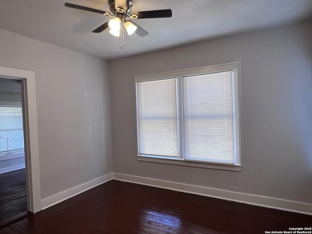 unfurnished room with dark wood-type flooring and ceiling fan