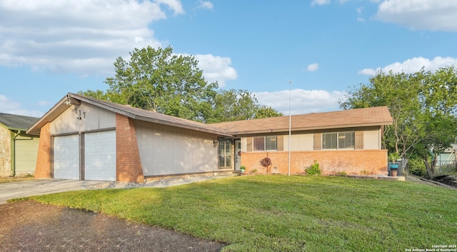 single story home featuring a garage and a front lawn