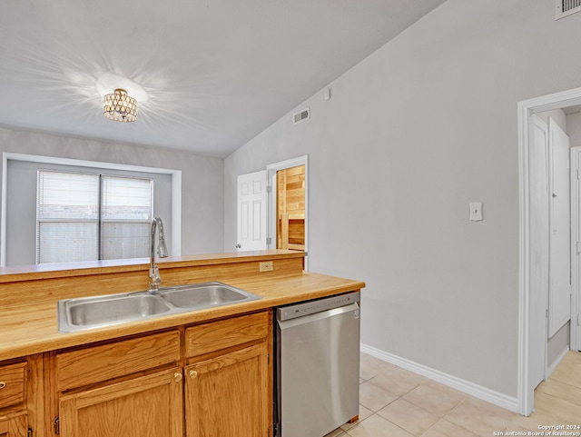 kitchen featuring sink, vaulted ceiling, stainless steel dishwasher, light tile patterned floors, and a notable chandelier