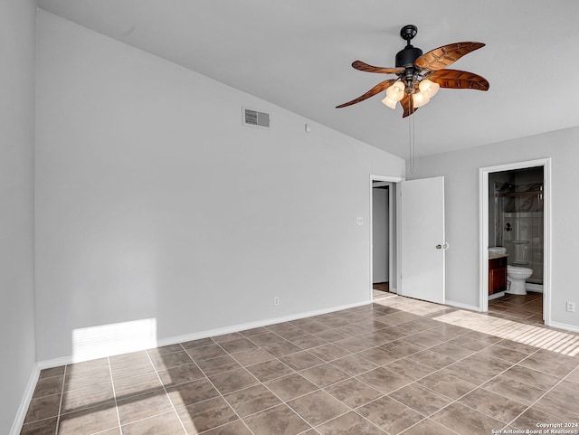 unfurnished bedroom with tile patterned floors, ceiling fan, connected bathroom, and vaulted ceiling