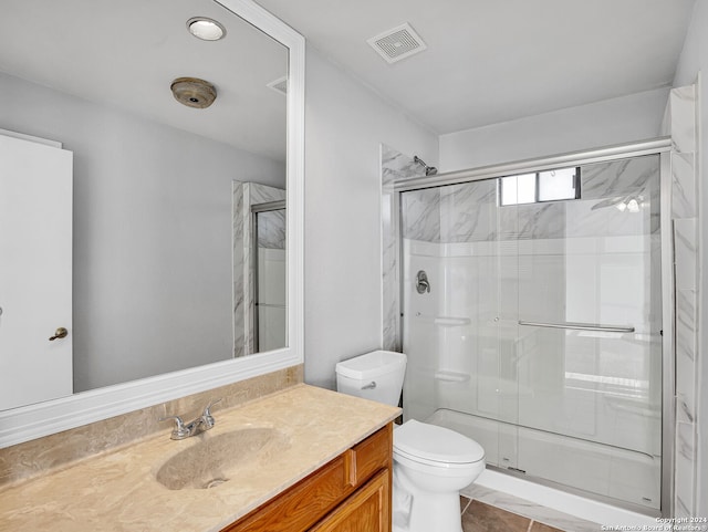 bathroom featuring tile patterned floors, vanity, walk in shower, and toilet