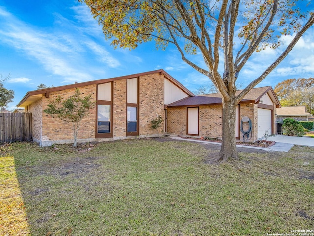 view of front facade with a front lawn and a garage