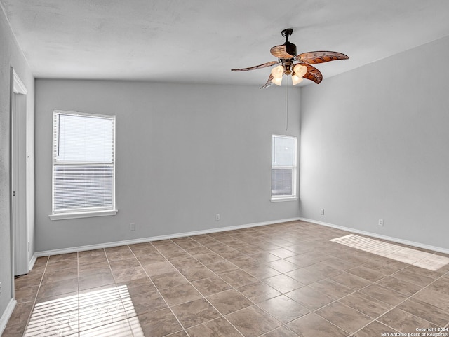 empty room with light tile patterned floors and ceiling fan