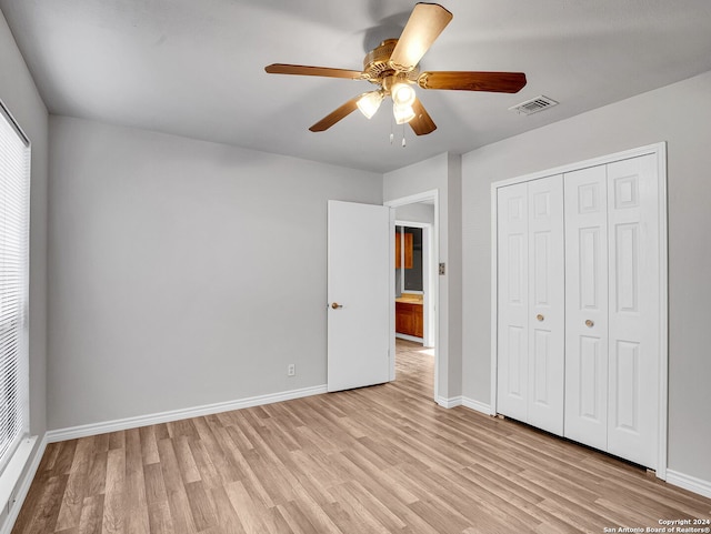 unfurnished bedroom with a closet, light hardwood / wood-style flooring, and ceiling fan