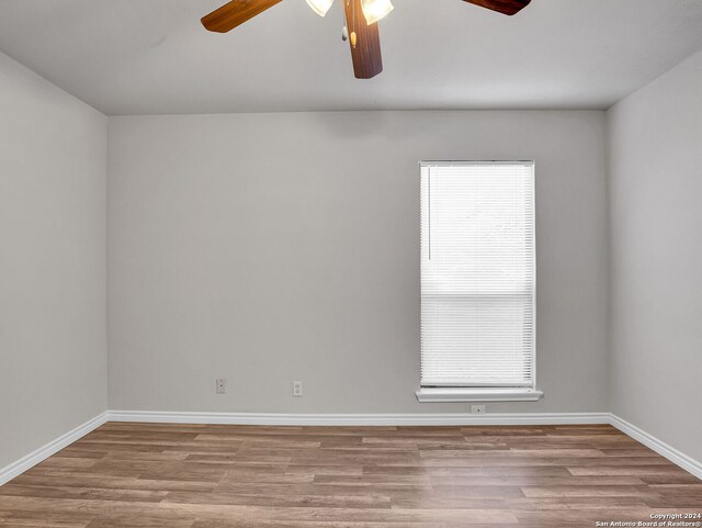 unfurnished room with ceiling fan, a healthy amount of sunlight, and light hardwood / wood-style flooring