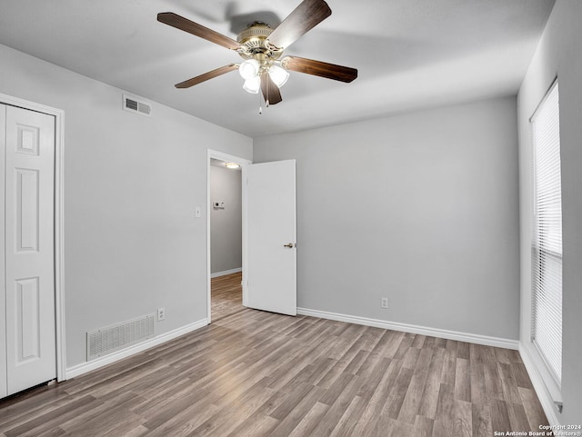 spare room with ceiling fan and light hardwood / wood-style floors