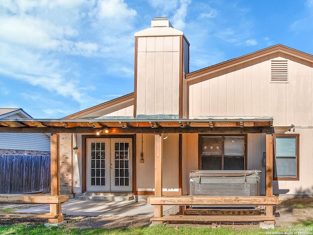 rear view of property featuring french doors