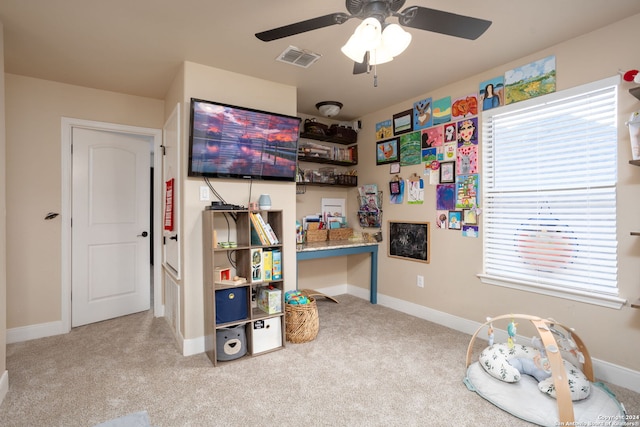 game room with light carpet and ceiling fan