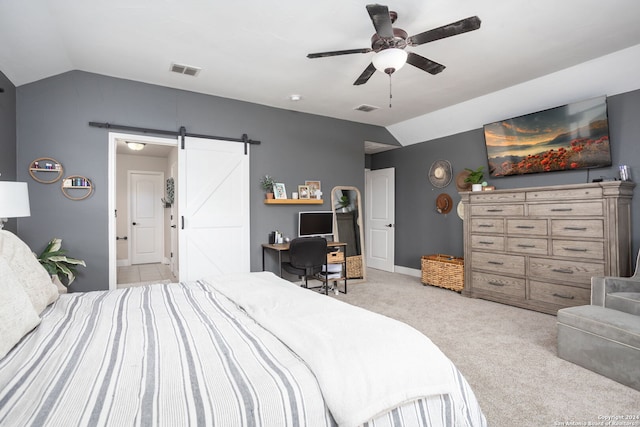 bedroom with light carpet, a barn door, vaulted ceiling, and ceiling fan