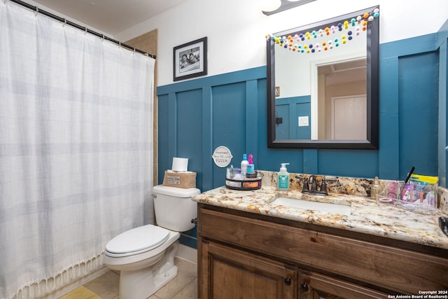 bathroom featuring tile patterned floors, vanity, and toilet