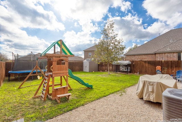 view of play area with a lawn, a storage unit, central AC unit, and a trampoline